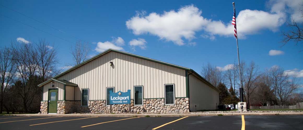 Lockport Township Hall building with the American flag on a bright sunny day